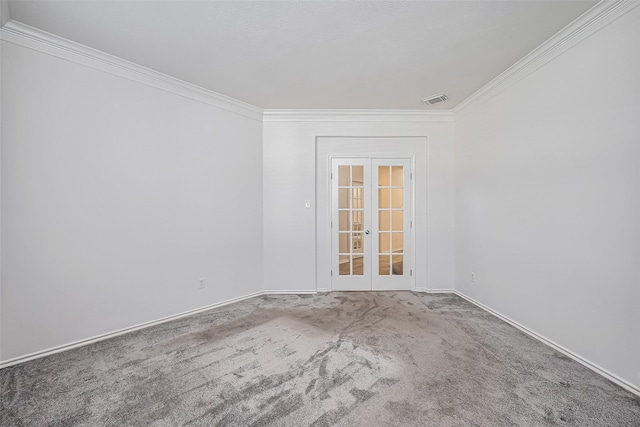 carpeted spare room featuring ornamental molding, french doors, visible vents, and baseboards