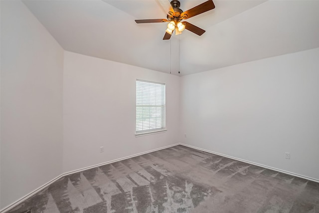 empty room featuring vaulted ceiling, carpet floors, and a ceiling fan