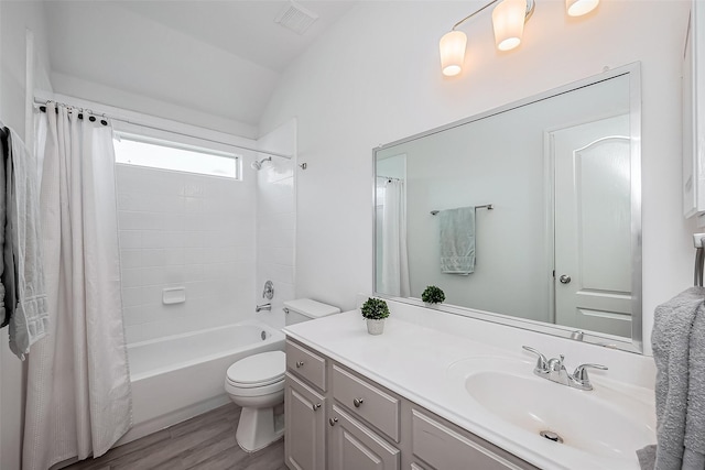 bathroom featuring shower / bath combination with curtain, lofted ceiling, visible vents, toilet, and vanity