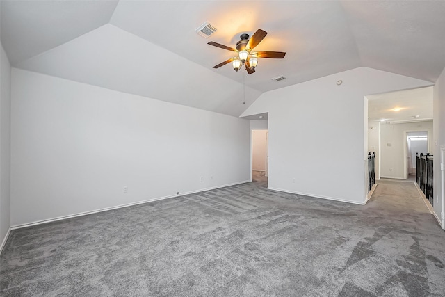 interior space featuring carpet floors, visible vents, and vaulted ceiling