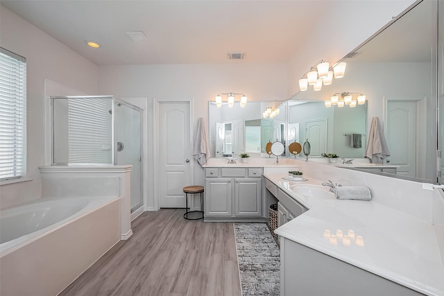 bathroom with visible vents, a shower stall, vanity, and a bath