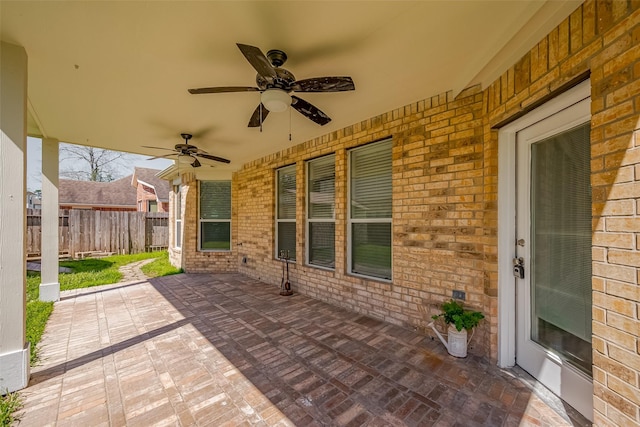 view of patio / terrace featuring fence and a ceiling fan