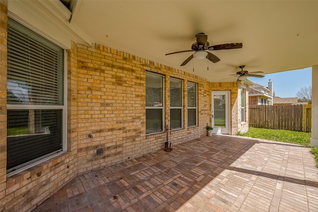 view of patio / terrace with ceiling fan and fence