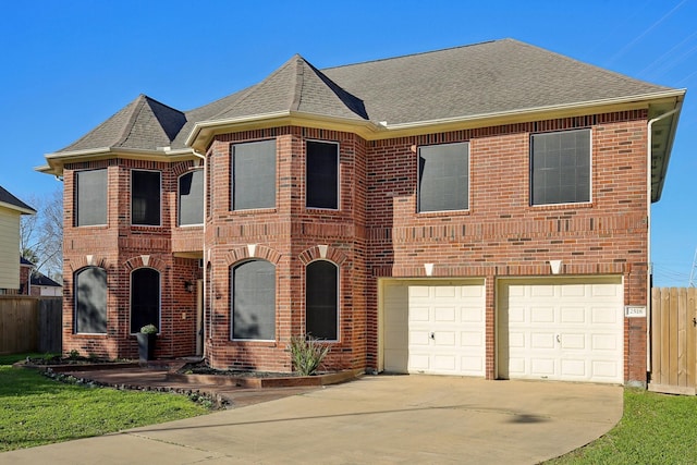 view of front of home with a shingled roof, concrete driveway, brick siding, and fence