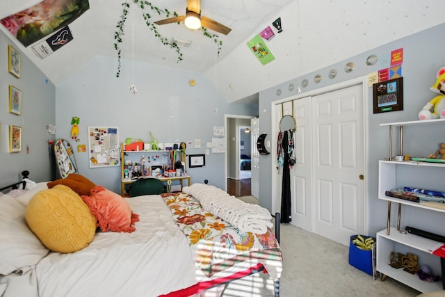 bedroom featuring lofted ceiling, carpet floors, visible vents, a ceiling fan, and a closet