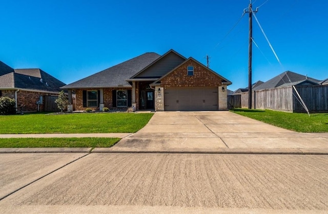 view of front facade featuring a garage, concrete driveway, fence, a front lawn, and brick siding