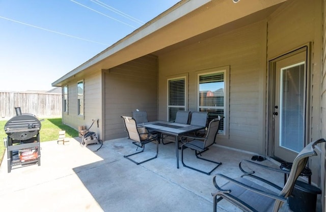 view of patio with fence and outdoor dining space