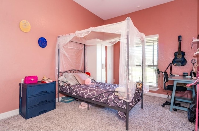 bedroom featuring lofted ceiling, baseboards, and carpet flooring