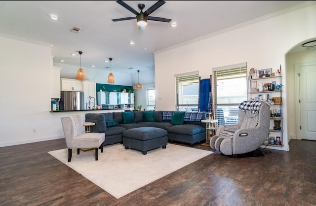 living room featuring plenty of natural light, dark wood-style flooring, and crown molding