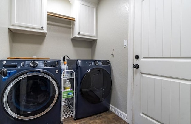 laundry room with cabinet space, baseboards, washer and clothes dryer, a textured wall, and dark wood-style flooring