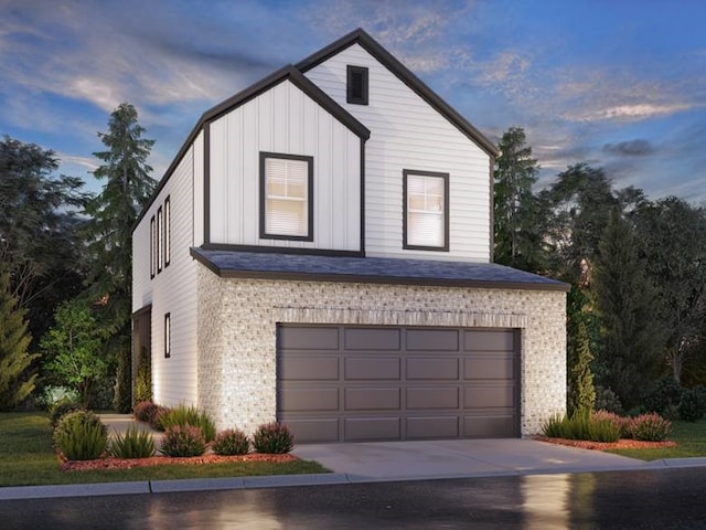 view of front of house featuring board and batten siding, concrete driveway, brick siding, and a garage