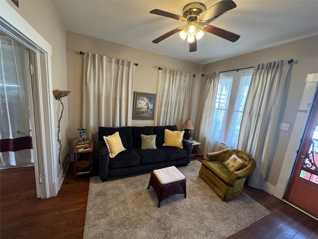 living room with ceiling fan and wood finished floors