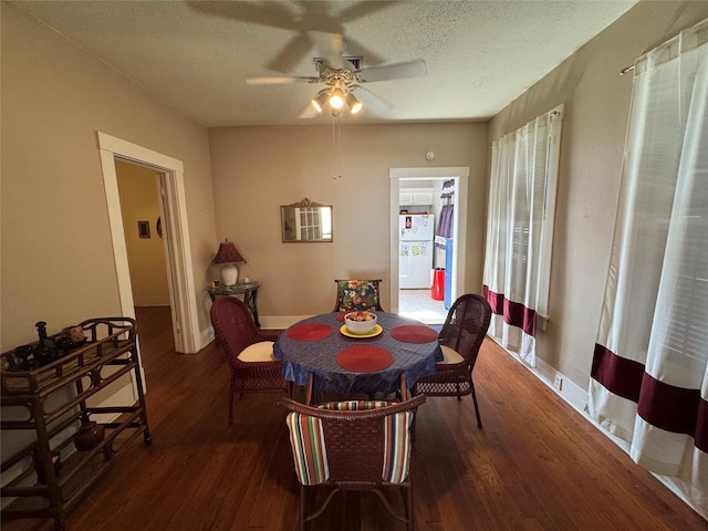 dining space featuring a textured ceiling, baseboards, and wood finished floors