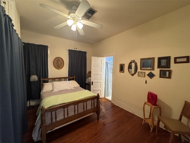 bedroom featuring ceiling fan, wood finished floors, visible vents, and baseboards