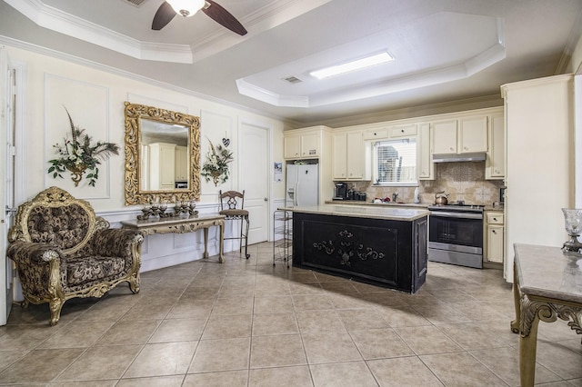 kitchen with white refrigerator with ice dispenser, ornamental molding, stainless steel electric range, decorative backsplash, and a tray ceiling