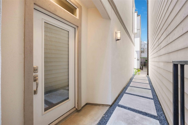 property entrance with stucco siding