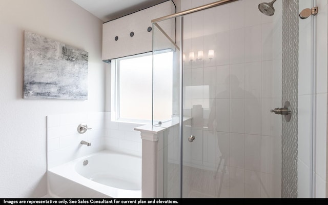 bathroom with a stall shower and a garden tub