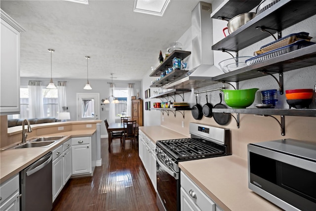 kitchen featuring stainless steel appliances, a sink, light countertops, open shelves, and dark wood finished floors