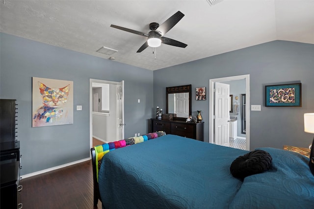 bedroom with baseboards, connected bathroom, lofted ceiling, ceiling fan, and wood finished floors