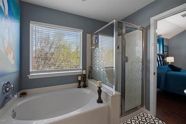 ensuite bathroom with a stall shower, visible vents, a garden tub, and connected bathroom