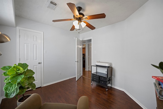 interior space featuring a ceiling fan, wood finished floors, visible vents, and baseboards