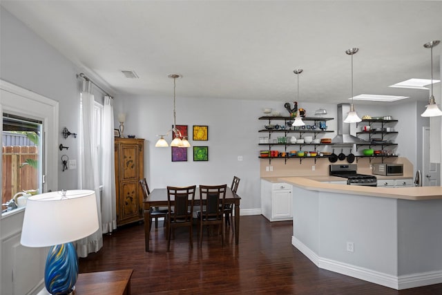 dining area featuring baseboards, visible vents, and dark wood finished floors