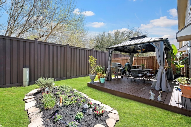 view of yard with outdoor dining area, a fenced backyard, a deck, and a gazebo