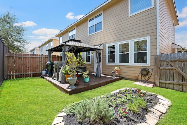 back of property featuring a yard, a fenced backyard, a deck, and a gazebo