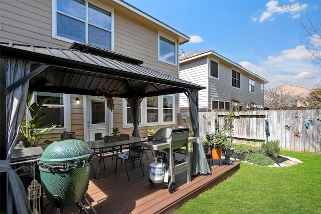 wooden deck featuring a yard, outdoor dining space, and fence