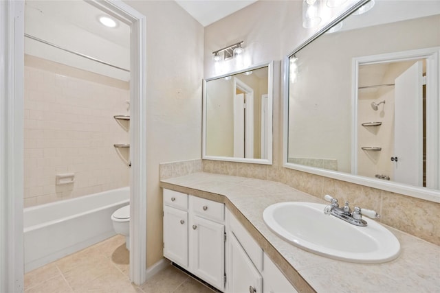 bathroom with tile patterned flooring, shower / bath combination, vanity, and toilet