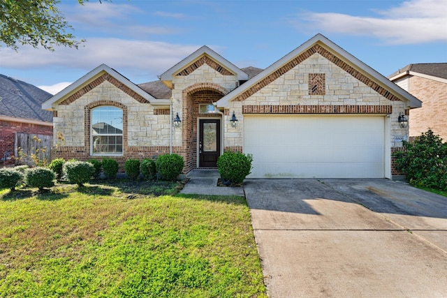 french country style house featuring driveway, brick siding, an attached garage, and a front yard