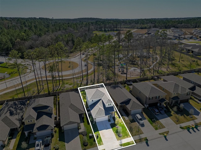 birds eye view of property with a residential view and a view of trees