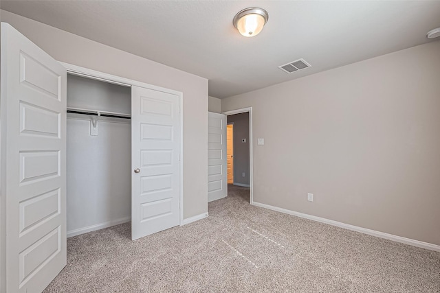 unfurnished bedroom with visible vents, baseboards, carpet, and a closet