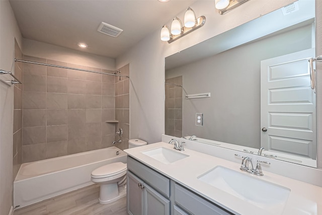 bathroom with a sink, visible vents, and toilet