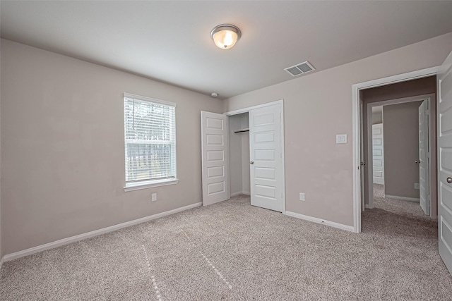 unfurnished bedroom featuring baseboards, visible vents, and carpet floors