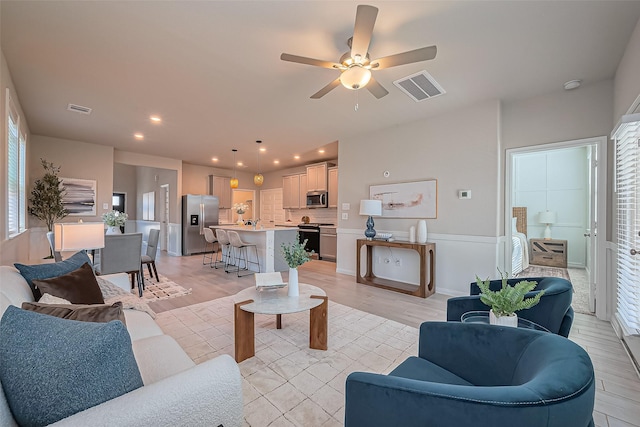 living area with visible vents, recessed lighting, a ceiling fan, and light wood-style floors