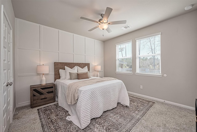 carpeted bedroom with visible vents, ceiling fan, and baseboards