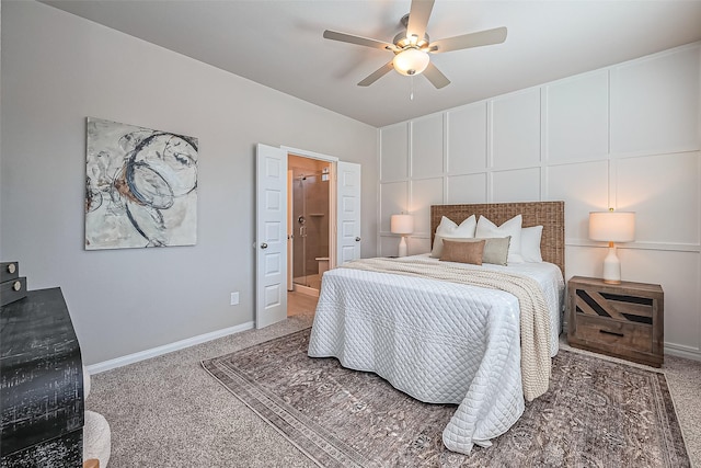 carpeted bedroom with ensuite bath, a ceiling fan, and baseboards