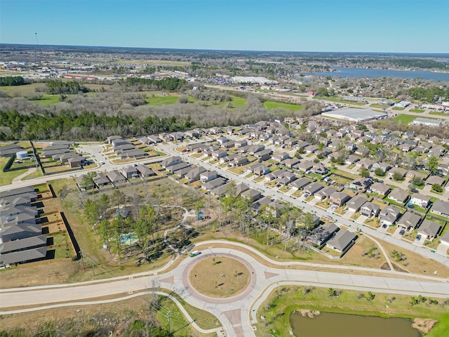 drone / aerial view featuring a residential view and a water view