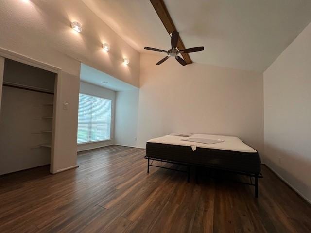 bedroom with ceiling fan, vaulted ceiling with beams, and wood finished floors