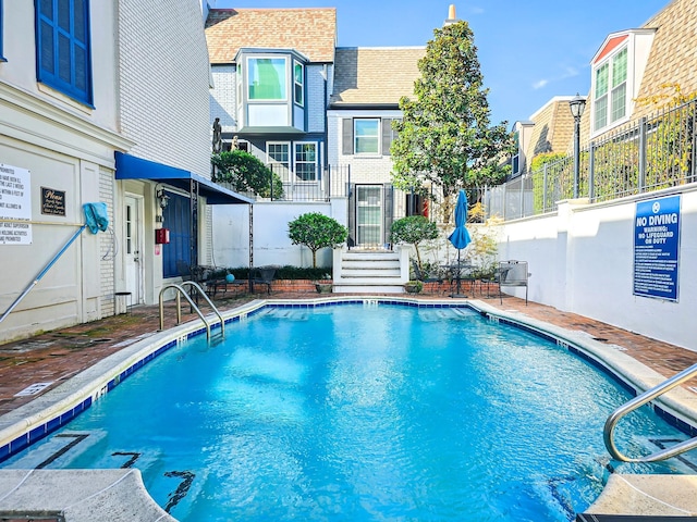 community pool featuring fence