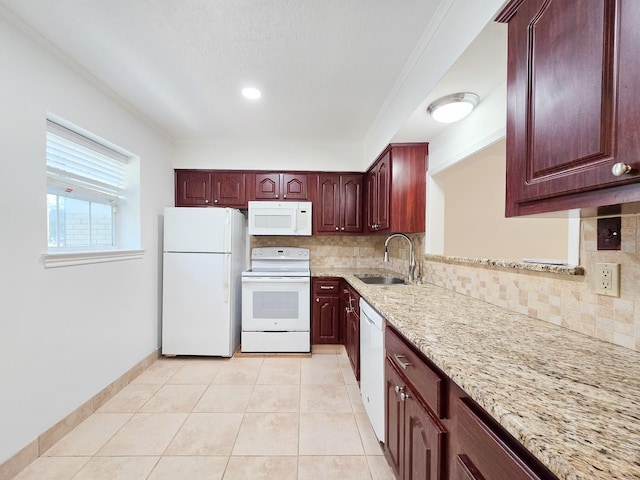 kitchen featuring white appliances, light tile patterned floors, light stone countertops, a sink, and decorative backsplash