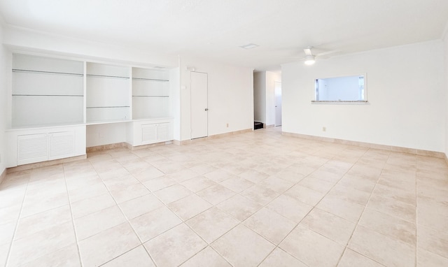 unfurnished room featuring built in features, baseboards, and ceiling fan