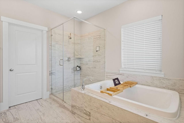 bathroom featuring marble finish floor, a stall shower, and a bath