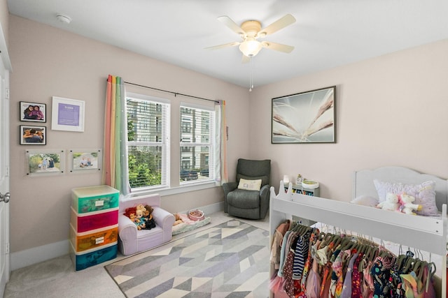 carpeted bedroom featuring ceiling fan and baseboards