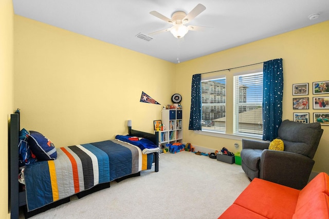 bedroom featuring visible vents, ceiling fan, and carpet flooring