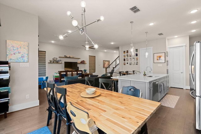 dining area with visible vents, dark wood finished floors, ceiling fan, stairway, and recessed lighting