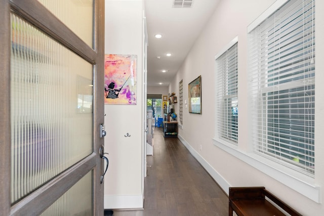 hallway with visible vents, baseboards, dark wood finished floors, and recessed lighting