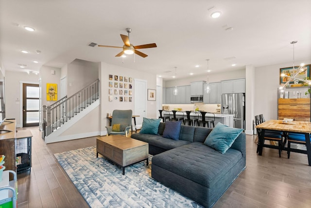 living area featuring stairs, wood finished floors, and recessed lighting