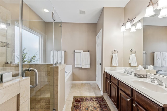 bathroom with a garden tub, a sink, a shower stall, and double vanity